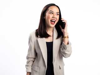 Fototapeta premium A portrait of an Indonesian Asian woman wearing a cream-colored blazer, talking on the phone. Isolated against a white background.