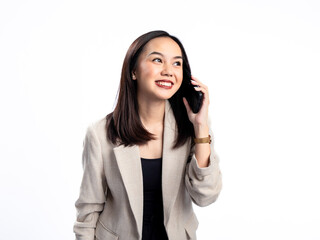 Fototapeta premium A portrait of an Indonesian Asian woman wearing a cream-colored blazer, talking on the phone. Isolated against a white background.