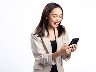 A portrait of an Indonesian Asian woman wearing a cream-colored blazer, looking happy while...