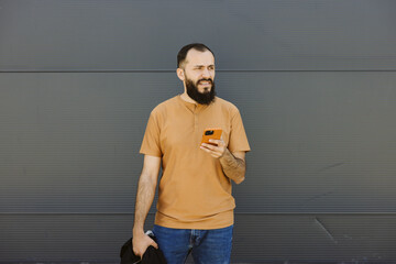 Bearded caucasian male waiting and checking his phone