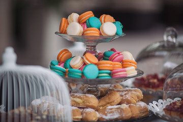 Tasty desserts, cakes and pastry on the wedding sweet buffet. macaroon on candy bar on holiday,...