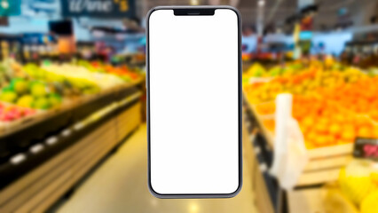 holding blank screen for text on smartphone, mobile, cell phone with blurry vegetable shelf background.,  supermarket Blank screen mobile phone for graphic display montage.