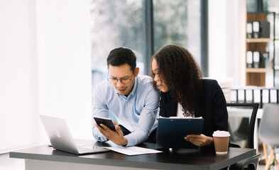 Business leading team meeting and using tablet and laptop with financial in office