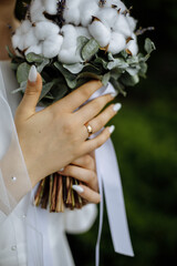 The bride is holding a wedding bouquet made of cotton