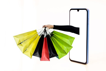 Hands with paper shopping bags outstreched from cellphone screen towards copy space, white background, isolated. Creative image for delivery service mobile application concept