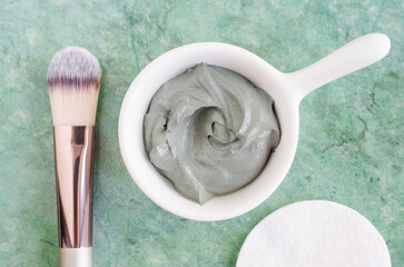 Gray bentonite clay in a bowl. Clay texture close up. Diy mask and body wrap recipe. Natural beauty treatment and spa.