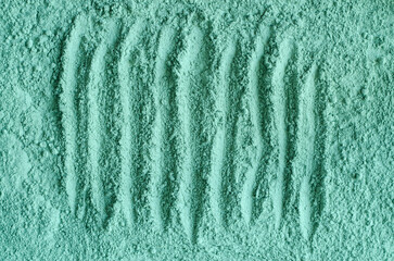 Green bentonite facial clay powder (alginate mask, eye shadow) texture close up, selective focus....