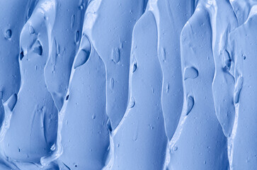 Fototapeta premium Light blue bentonite facial clay (alginate mask, face cream, body wrap) texture close up, selective focus. Abstract background with brush strokes.
