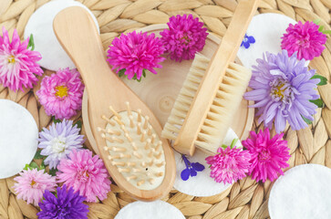 Wooden hairbrush and massage body brush. Eco friendly toiletries. Natural beauty treatment, hair care or zero waste concept. Top view, copy space.