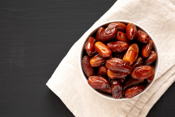 Organic Dry Deglet Nour Dates in a Bowl, top view. Space for text.
