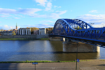 View of the bright blue Józef Piłsudski Bridge on a sunny autumn day