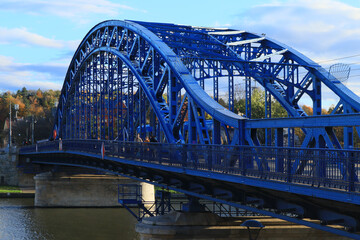 View of the bright blue Józef Piłsudski Bridge on a sunny autumn day