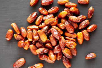 Organic Dry Deglet Nour Dates on a black background