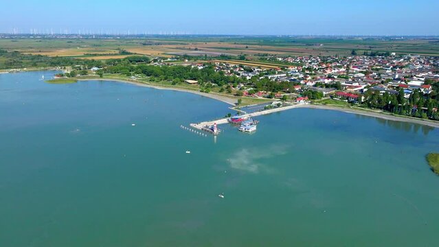The Lighthouse Podersdorf At The Main Pier With Seaside Resort In Neusiedl am See, Austria. Aerial Wide Shot