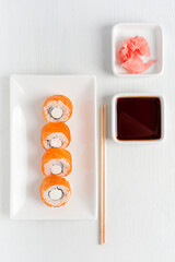 Top view of Philadelphia roll sushi made with smoked or raw salmon fish, cream cheese, boiled rice...