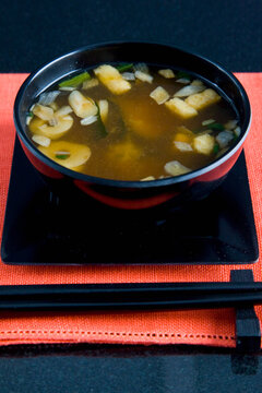 Close up of a place setting with a serving of miso soup
