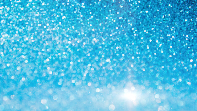 Shining sparkling blue blurred background for holiday design. Christmas abstract sparkles, selective focus. Web banner