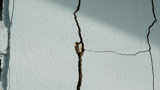 Cracks in the cement wall White cement of buildings damaged by earthquakes