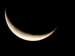 moon in wanning crescent phase with dark sky in the background 