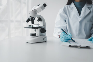 Chemist taking notes on research data, Scientist is working in the laboratory, Chemist is analyzing...
