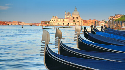 Gondolas on Grand Canal with Basilica Santa Maria della Salute in Venice as a backdrop.