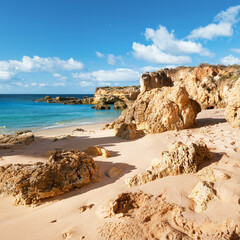 Golden beaches and sandstone cliffs near Albufeira, Portugal, square composition.