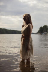 young shy cosplay woman  in dress on an rainy day on sea