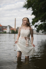 young shy cosplay woman  in dress on an rainy day on sea