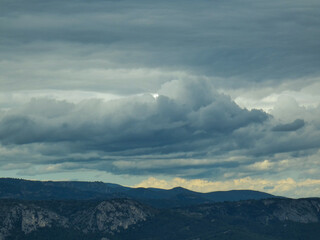 Stormy skies with threatening gray clouds hanging over the Luberon mountains in Provence in France 