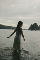 young shy cosplay woman  in dress on an rainy day on sea