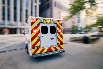 Ambulance car of emergency medical service in blurred motion on city street. Themes healthcare,...