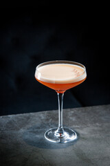 side view of tropical cocktail with foam on top in martini glass
