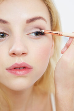 Close up of Young Woman Applying Eye Shadow

