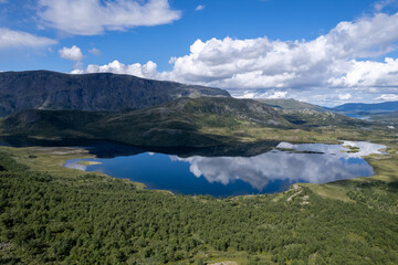 Naklejka na ściany i meble Aerial view above Jotunheimen Norway - Glacier fed lakes in the highlands and valleys of Central Norway