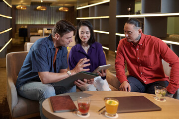 Businessman sharing ideas with coworkers in meeting when discussing project development