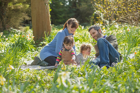 Happy Family Sitting in Garden
