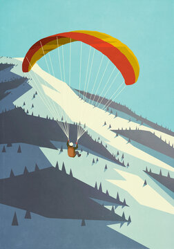Man paragliding in snowy winter mountains
