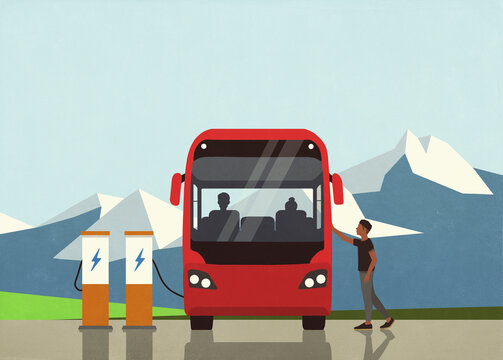 Man boarding bus at electric charging station in mountains
