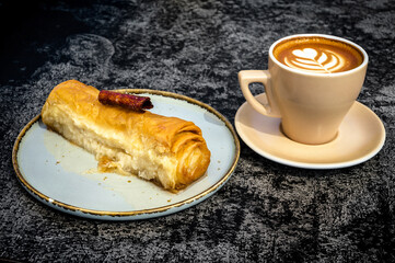 A cup of cappuccino and cake close-up. Perfect for coffee shop and dessert-themed projects.