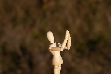 A wooden mannequin folded his hands to pray, asking for mercy.