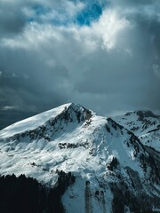 Scenic view of majestic snow-capped mountains against a cloudy sky.