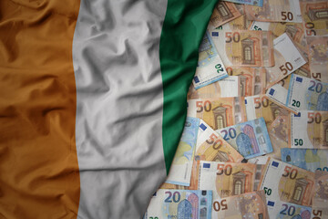 colorful waving national flag of cote divoire on a euro money background. finance concept