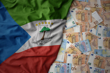 colorful waving national flag of equatorial guinea on a euro money background. finance concept