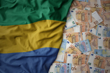 colorful waving national flag of gabon on a euro money background. finance concept