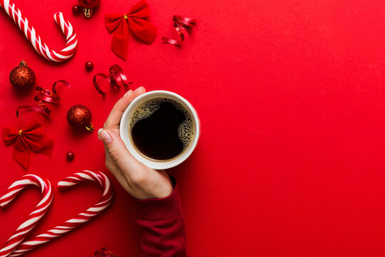 Woman holding cup of coffee. Woman hands holding a mug with hot coffee. Winter and Christmas time concept