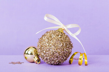 Christmas ball on colored background. decoration bauble with ribbon bow with copy space