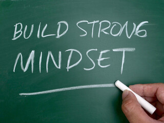 Build strong mindset, quote text written on chalkboard, motivation inspirational