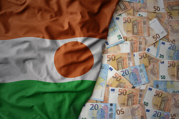 colorful waving national flag of niger on a euro money background. finance concept