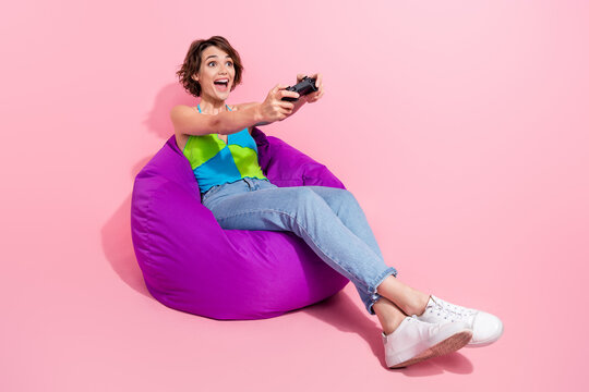 Full body photo of woman spend free time in summer gamer holding joystick crazy mortal kombat match isolated on pink color background