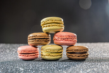 colorful macaroons on a table and dark background